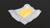 Butter with paper on ground