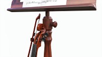 Violin with bow and wooden music note stand