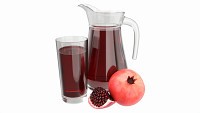 Jug and glass with pomegranate juice and fruit